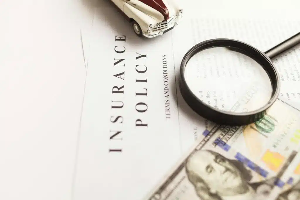 Car insurance policy document with magnifying glass and car model representing vehicle insurance coverage in the UAE